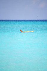 Female relaxing in the caribbean waters.