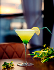 yellow-green alcohol cocktail with salt at the edges