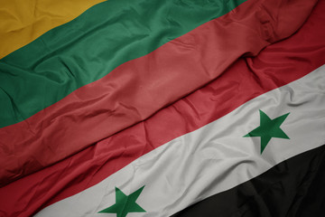 waving colorful flag of syria and national flag of lithuania.