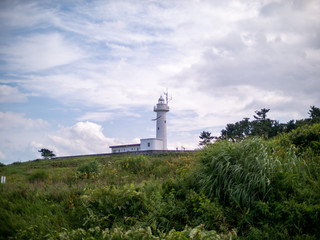 Fototapeta na wymiar Lighthouse at Tanesashi kaigan coast. Slightly soft filtered.