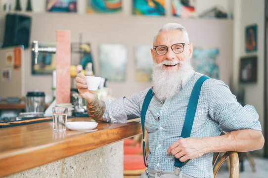 Senior bearded man drinking coffee sitting bar counter - Happy mature male having fun enjoying time outdoor - Elderly people lifestyle concept