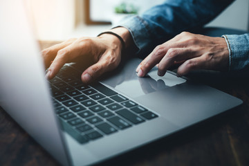 using computer.hand typing message on keyboard laptop chatting friend search information form...