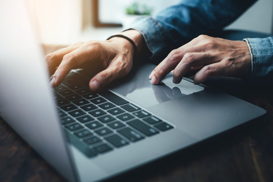 using computer.hand typing message on keyboard laptop chatting friend search information form internet while working on computer concept for technology device contact communication business people