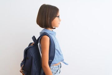 Beautiful student child girl wearing backpack and glasses over isolated white background looking to...