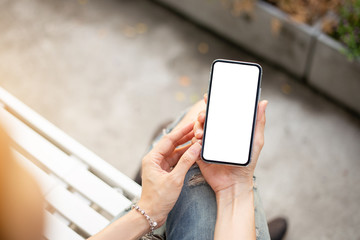 Mockup image blank white screen cell phone.men hand holding texting using mobile at outdoor park.background empty space for advertise text.people contact marketing business and technology 