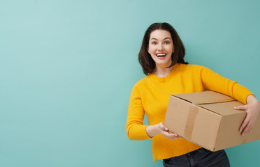 woman is holding cardboard box