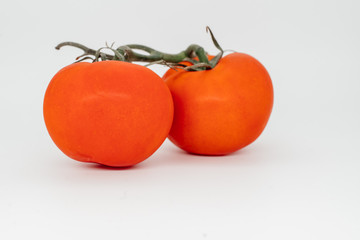 Red tomato on a white background close-up