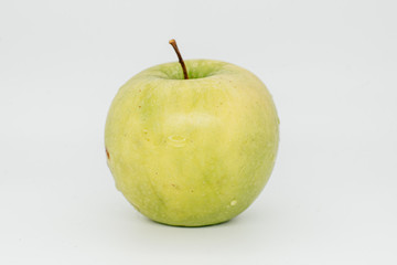 Green apple on a white background close-up