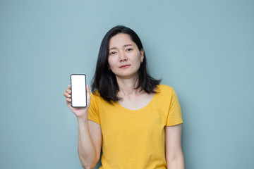 Naklejka premium Mockup image blank white screen cell phone.men hand holding texting using mobile on background empty space for advertise text.people contact marketing business and technology 
