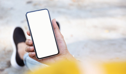 Mockup image blank white screen cell phone.men hand holding texting using mobile at outdoor park.background empty space for advertise text.people contact marketing business and technology 