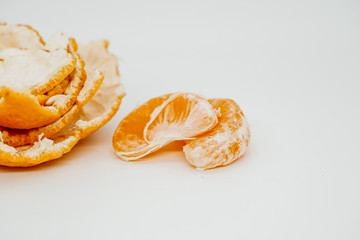 Slices of juicy tangerine disassembled into pieces close-up