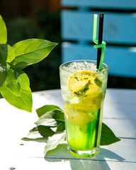 cold mojito with slices of lemon and mint leaves
