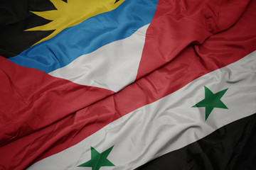 waving colorful flag of syria and national flag of antigua and barbuda.