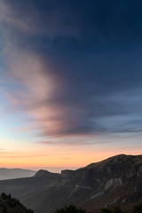 Vertical background with beautiful sunset in the mountains. Scenic view