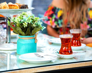 black tea in armudu glass and flowers
