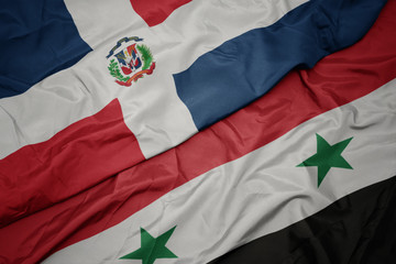 waving colorful flag of syria and national flag of dominican republic.