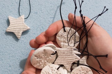 Cute baby child hands, handful with small ornament pendant figure, made of self drying white clay...