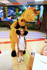 little girl on the background of the entertainment center