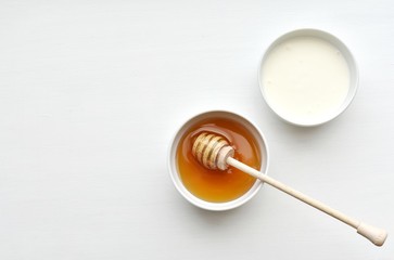 Honey and yogurt, ingredients for homemade natural face mask, skin treatment, top view, copy space.