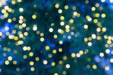 Abstract blur lights on dark blue background. Blurred yellow round glitters. Christmas tree lights.