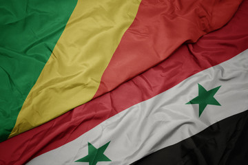 waving colorful flag of syria and national flag of republic of the congo.