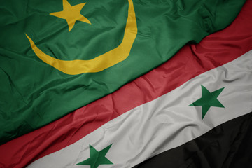waving colorful flag of syria and national flag of mauritania.