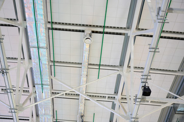 Photo of ceiling structures in a white building.