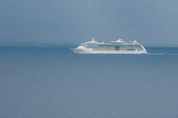 Fototapeta na wymiar Distant view of touristic ship in the mediterranean sea. Travel.