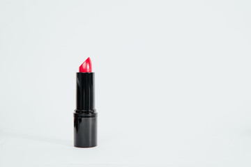 Red lipstick isolated on a bright white background. Fashion and beauty concept. Women's use of lipstick to enhance lip color.