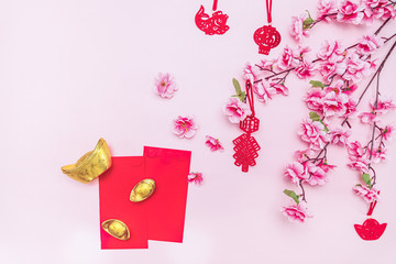 Flat lay Chinese lunar new year offering red envelope on pink background, Translation of text appear in image: Prosperity, rich and healthy.