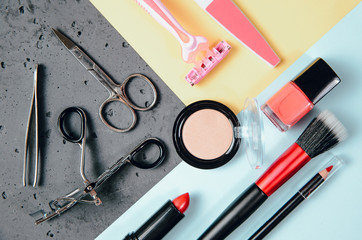 Top view on set of woman make up cosmetics on pastel colors. Beauty and fashion concept. On table...