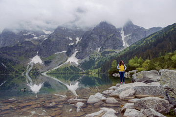woman relaxing on the lake and mountains sunny landscape