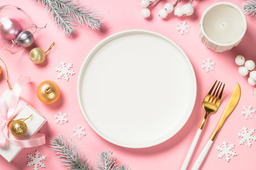 Christmas table setting on pink top view.