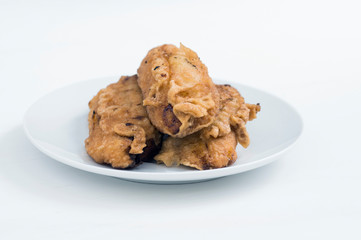 Close up of fried bananas, banana fritters or pisang goreng on white background