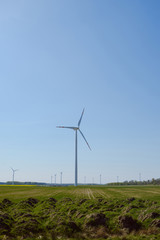 Fototapeta na wymiar Bright blue sky moving and wind turbine