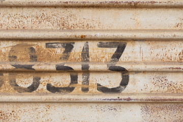 wall of an iron wagon with numbers inscription