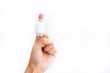 Injured painful finger with white gauze bandage