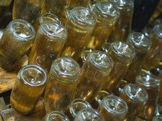 Stages of champagne production.Remuage is the stage of removing wine from the sediment. Close-up of a bottle in a howl.