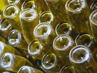 Stages of champagne production.Remuage is the stage of removing wine from the sediment. Close-up of a bottle in a howl.
