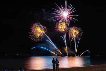 Fototapeta na wymiar Fireworks display and showing of Pattaya International Fireworks Festival on Pattaya beach, Thailand.