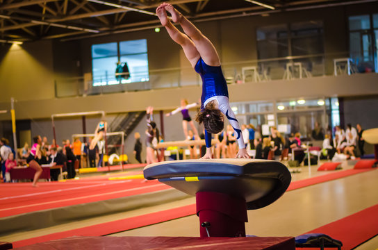 Young gymnast girl performing jump