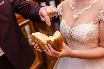 Groom salts loaf at wedding