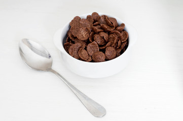 Bowl of cereals and spoon for breakfast on white background