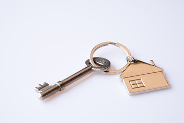 House key ring with antique key on white background. Property investment. Home finance concept.