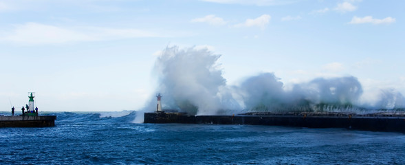 Fototapeta na wymiar Waves crashing over harbour wall, Cape Town