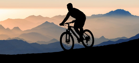 Cyclist in pants and fleece jacket on a modern carbon hardtail bike with an air suspension fork...