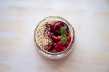 Chia pudding with acai bowl with berries and cherries on the wood table