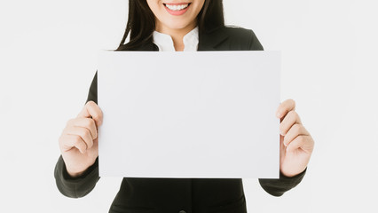 Showing blank paper for text - woman holding big business paper A4 sign with copy space.Sign and businesswoman with smiley face. Happy smiling woman isolated on white background.Concept for Business.