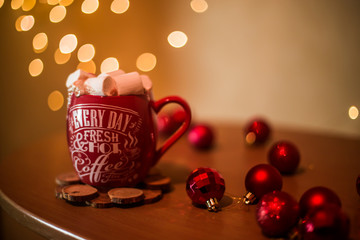 on the table is a cup with a drink and marshmallows