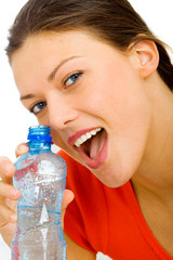 Happy woman drinking water from a bottle